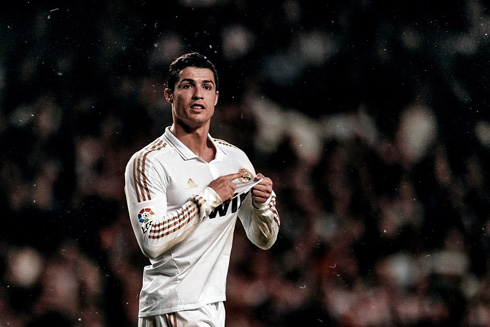 Cristiano Ronaldo pointing to Real Madrid symbol and badge on his shirt