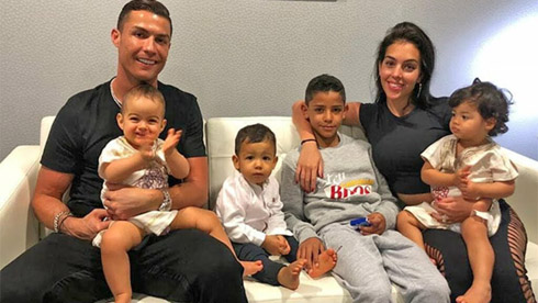 Cristiano Ronaldo sons and Georgina posing for a photo at home